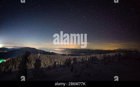 Stunning views of the European ski resort during the winter holidays on a cold starry winter night. Recreation and winter sports concept. Copyspace Stock Photo
