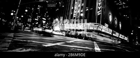 Low angle view of buildings lit up at night, Radio City Music Hall, Rockefeller Center, Manhattan, New York City, New York State, USA Stock Photo