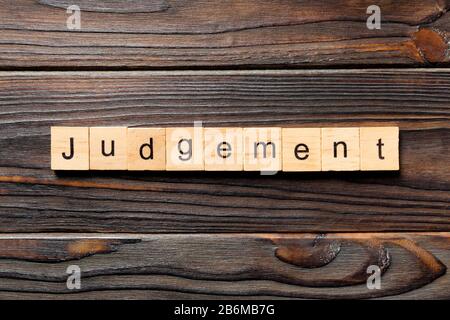 judgement word written on wood block. judgement text on table, concept. Stock Photo