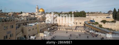 People praying at Western Wall with Dome of the Rock and Al-Aqsa Mosque in the background, Old City, Jerusalem, Israel Stock Photo