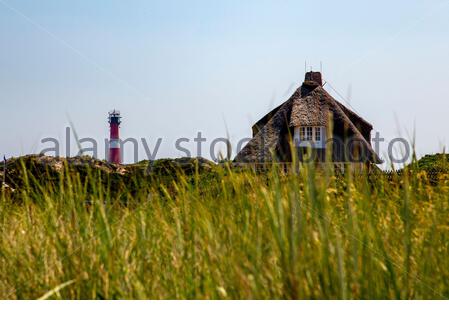 Hörnum lighthouse and thatched roof house on Sylt Island