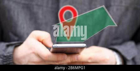 Man holding in hands smartphone while using navigation software Stock Photo