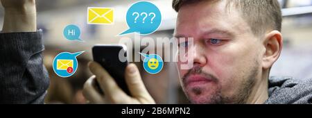 Handsome male using dating apps while traveling subway Stock Photo
