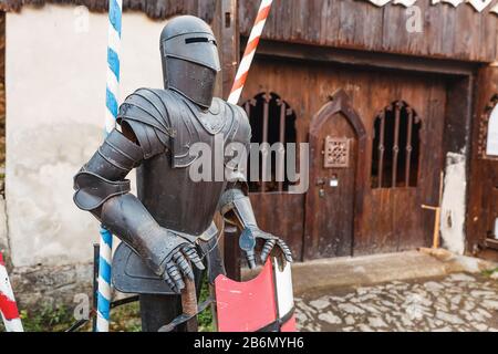 Medieval knight in armour near castle Stock Photo