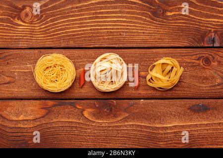 dried pasta on wooden background creative photo. Stock Photo