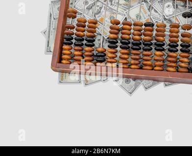 Old wooden abacus on a paper american dollars background. Bookkeeping, profit, business concept Stock Photo