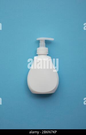 Bottle of anti bacterial handwwash on a blue background Stock Photo