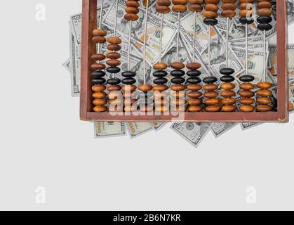 Old wooden abacus on a paper american dollars background. Bookkeeping, profit, business concept Stock Photo