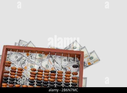 Old wooden abacus on a paper american dollars background. Bookkeeping, profit, business concept Stock Photo
