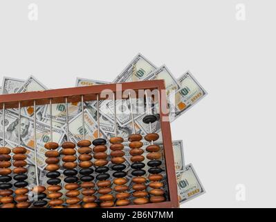 Old wooden abacus on a paper american dollars background. Bookkeeping, profit, business concept Stock Photo