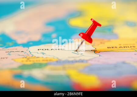 The location of the destination on the map Poland is indicated by a red pushpin. Poland is marked on the map with a red button Stock Photo