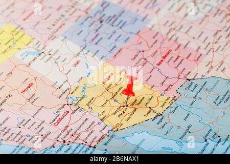 Red clerical needle on a map of the USA, Arizona and the capital Phoenix. Close up map of orizona with red tack, US map pin Stock Photo