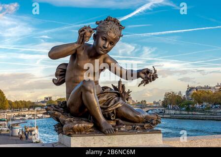 A sculpture of a nymph on the Alexander III bridge across Seine river in Paris, France