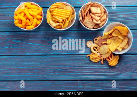 Differnt Types of Junk food, salty-sticks, salty-crackers on wooden table in still-life Stock Photo