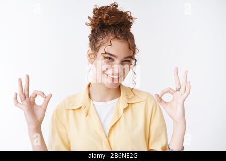 Count me in. Portrait confident energized good-looking assertive charming redhead female friend give okay ok gesture assure everything perfect work Stock Photo