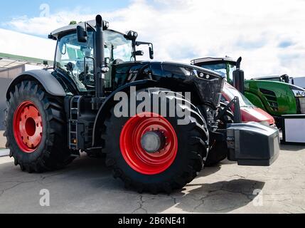 tractor with big wheels, machine for agricultural work and transportation of goods, close-up Stock Photo