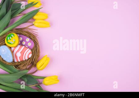 Easter cookies and tulips on a pink background Stock Photo