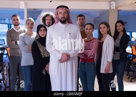 Portrait of young pretty successful multi-ethnic corporate close-knit team concept, arabian as a leader, european african ethnicity office workers pos Stock Photo