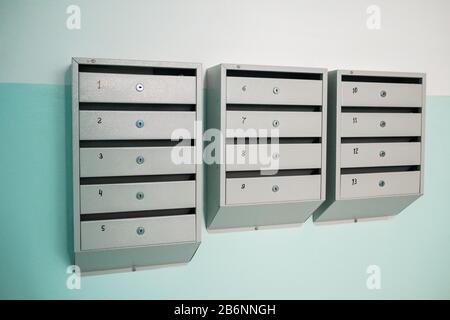 Mailboxes on the wall. New mail containers attached to the wall. Mailboxes in the entrance of an apartment building. Stock Photo
