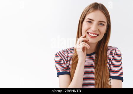 Close-up tender, feminine young happy girl in striped t-shirt, long chestnut hair, smiling toothy, tilt head entertained, touch cheek slightly with Stock Photo