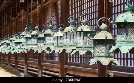 A row of bronze japanese lanterns in Kasuga-Taisha shrine in Nara. Stock Photo