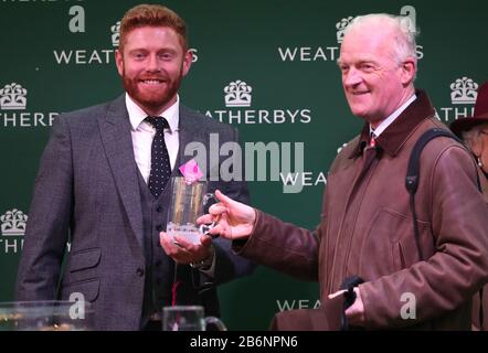 Jonny Bairstow (left) with trainer Willie Mullins during day two of the Cheltenham Festival at Cheltenham Racecourse. Stock Photo