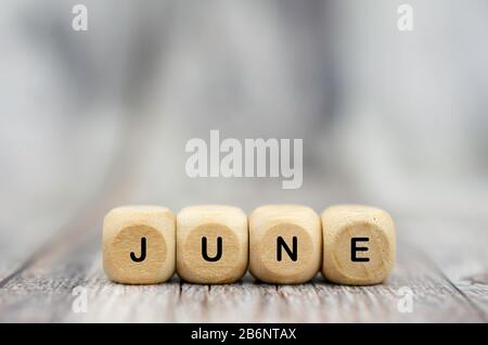 The word June on wooden cubes. Month of year Stock Photo