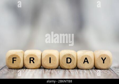 The word Friday on wooden cubes. Weekday concept Stock Photo