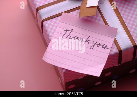 thank you message on gift box on pink background  Stock Photo