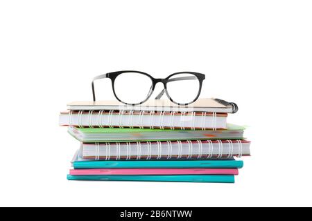 Pile of copybooks and glasses isolated on white background Stock Photo