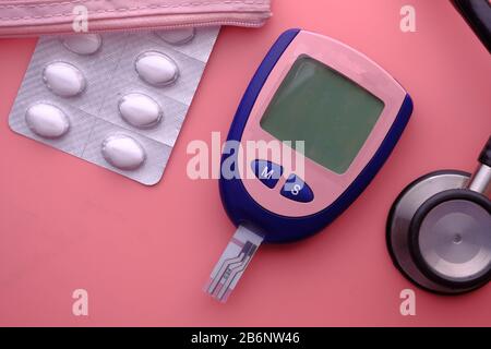 https://l450v.alamy.com/450v/2b6nw46/blood-sugar-measurement-for-diabetes-pills-and-stethoscope-2b6nw46.jpg