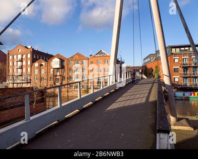 River frontage of former Fletland Mills converted warehouse buildings by the River Aire from Centenary Bridge in Leeds West Yorkshire England Stock Photo