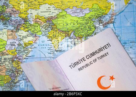 Opened Turkish passport on a world map. Stock Photo