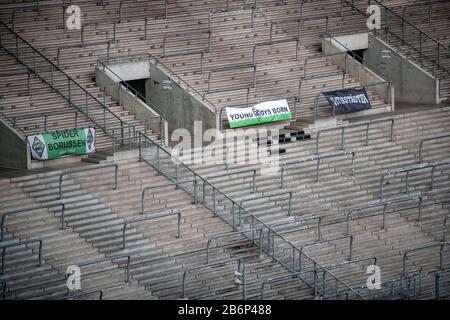 Monchengladach, Germany. 11th Mar, 2020. 11 March 2020, North Rhine-Westphalia, Mönchengladbach: Football: Bundesliga, Borussia Mönchengladbach - 1 FC Cologne, 21st matchday at Borussia-Park. Banners of the fans hang on the empty north curve. The game takes place without spectators as a ghost game because of the coronavirus. Photo: Fabian Strauch/dpa - IMPORTANT NOTE: In accordance with the regulations of the DFL Deutsche Fußball Liga and the DFB Deutscher Fußball-Bund, it is prohibited to exploit or have exploited in the stadium and/or from the game taken photographs in the form of sequence i Stock Photo