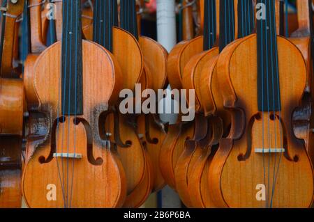 Violins hanging in  front view Stock Photo