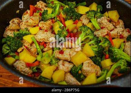Fried piece of turkey meat with onions and spices. Pieces of turkey carrot onion. The process of cooking vegetable stew with turkey. Steamed vegetable Stock Photo