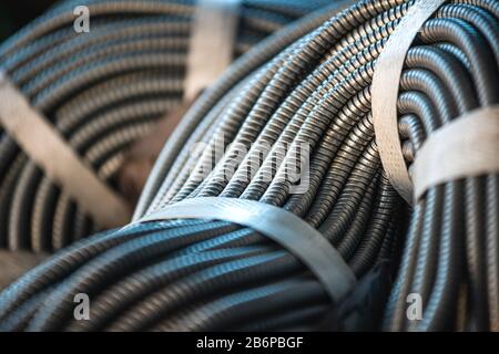 Close-up of a huge bundle of metal flexible tubes interconnected in production. The concept of modern electronic high voltage devices and specialized Stock Photo