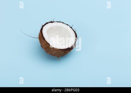 Fresh half natural coconut on blue background. Stock Photo