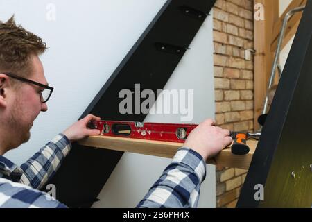 Home improvement handyman building staircase in a natural light Stock Photo