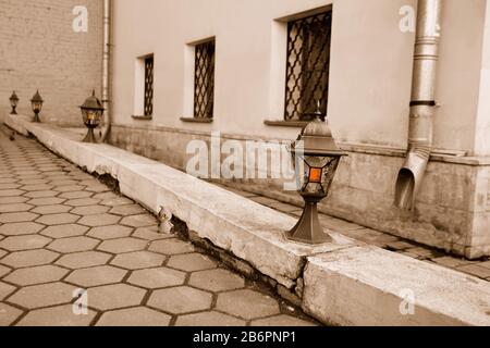 Small lanterns illuminate pavement with a tiny dwarf peeping out from the hole in the edge stone, Moscow, Russia Stock Photo