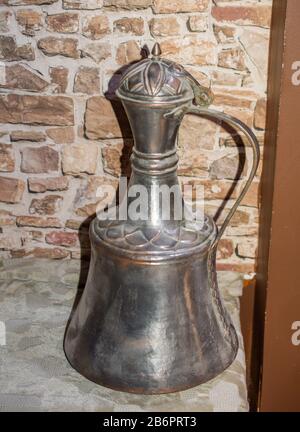 Very old style metal ewer water jar in view Stock Photo