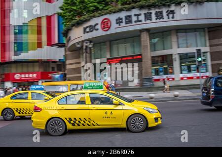 Chongqing, China - August 2019 : Yellow taxi driving on the busy and congested street Stock Photo