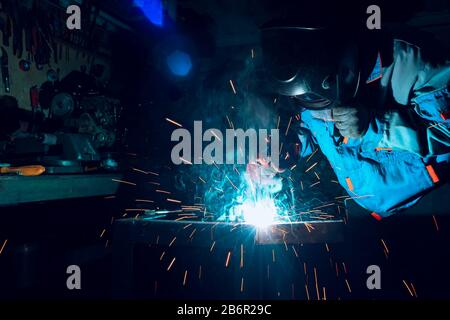 Welders working at the factory made metal Stock Photo