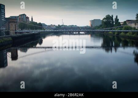 The river Clyde at sunrise on a summer’s day in Glasgow, Scotland. Stock Photo