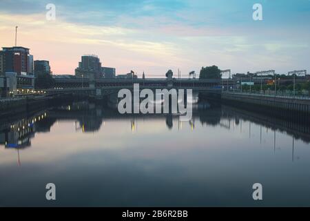 A bridge over River Clyde in Glasgow at sunrise on a summers day. Stock Photo