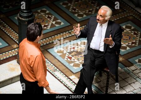 Side view of two men engrossed in a discussion. Stock Photo