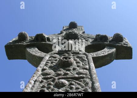 A close up of an ancient Celtic cross on the island of Skye in Scotland on a sunny day. Stock Photo