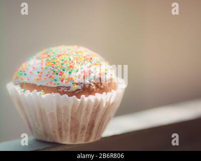 small easter cupcake wrapped in white paper. Stock Photo