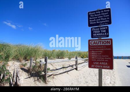 Caution Sign, warning of strong currents, sharks, Nauset Beach, Cape Cod National Seashore, Orleans, Cape Cod, Massachusetts, New England, USA Stock Photo