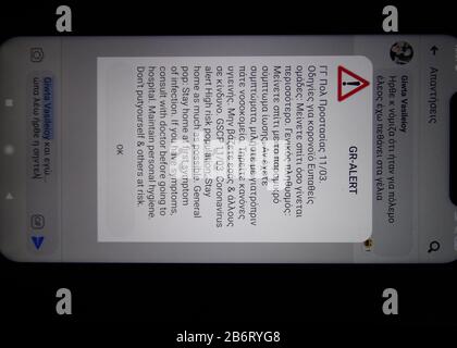 coronavirus, covid-19 red alert danger, caution, warning message with directions appeard on all greek civilians cellphones